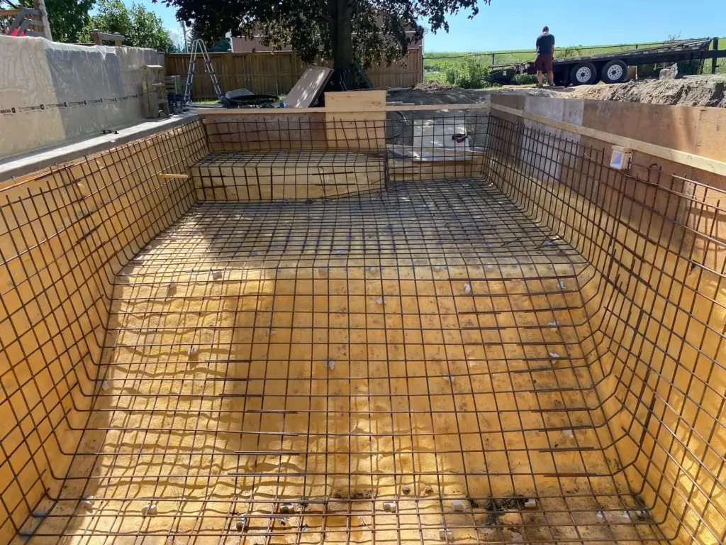 Custom shotcrete pool construction in Ontario showing the reinforced concrete shell and precision gunite application for a durable, luxury inground pool.