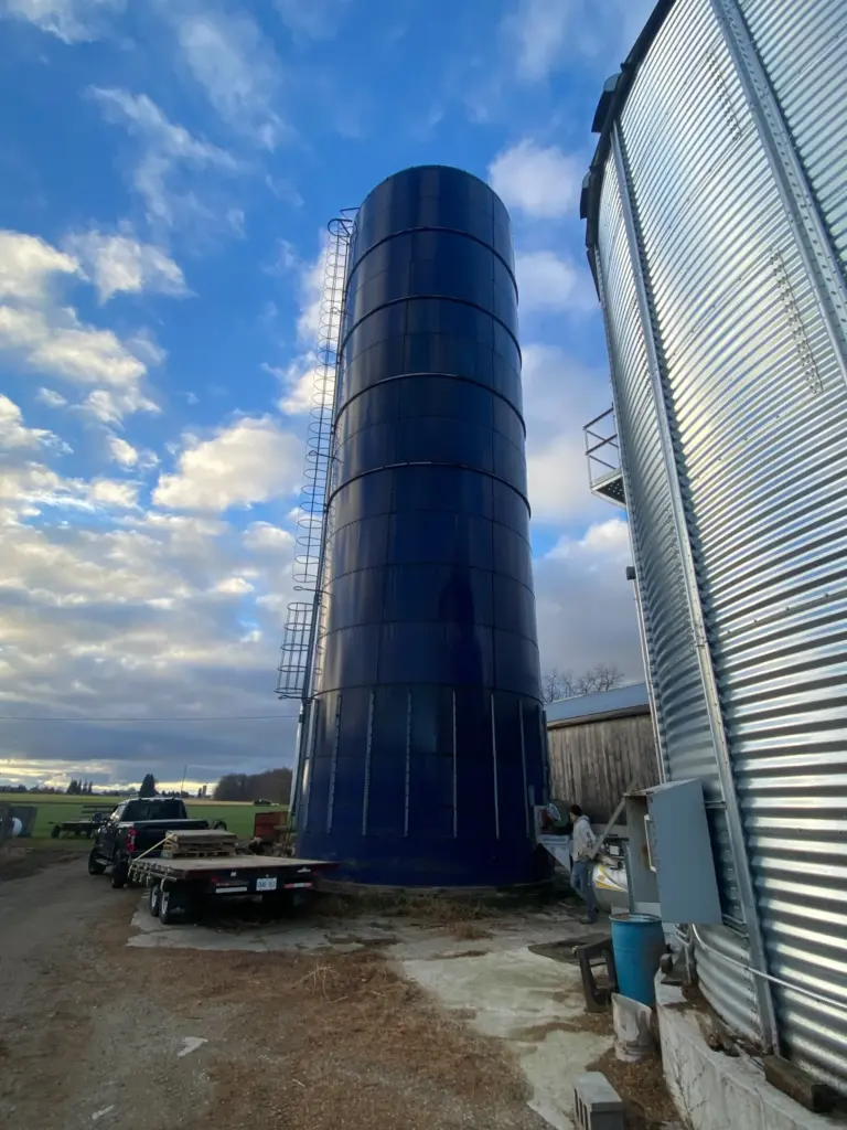 High-capacity 20' x 70' oxygen-limiting sealed steel silo for high-moisture grain storage, featuring a compact vertical footprint and airtight construction.