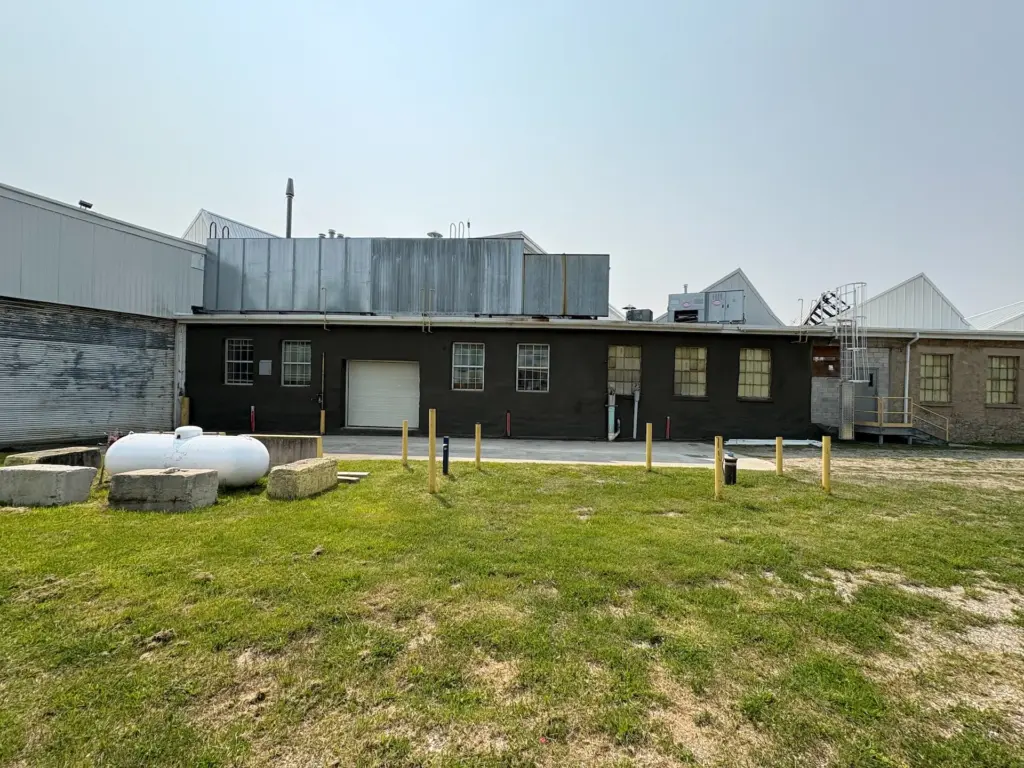 Industrial building wall restoration featuring a reinforced shotcrete (gunite) application and a smooth professional finish to enhance structural durability and moisture protection.
