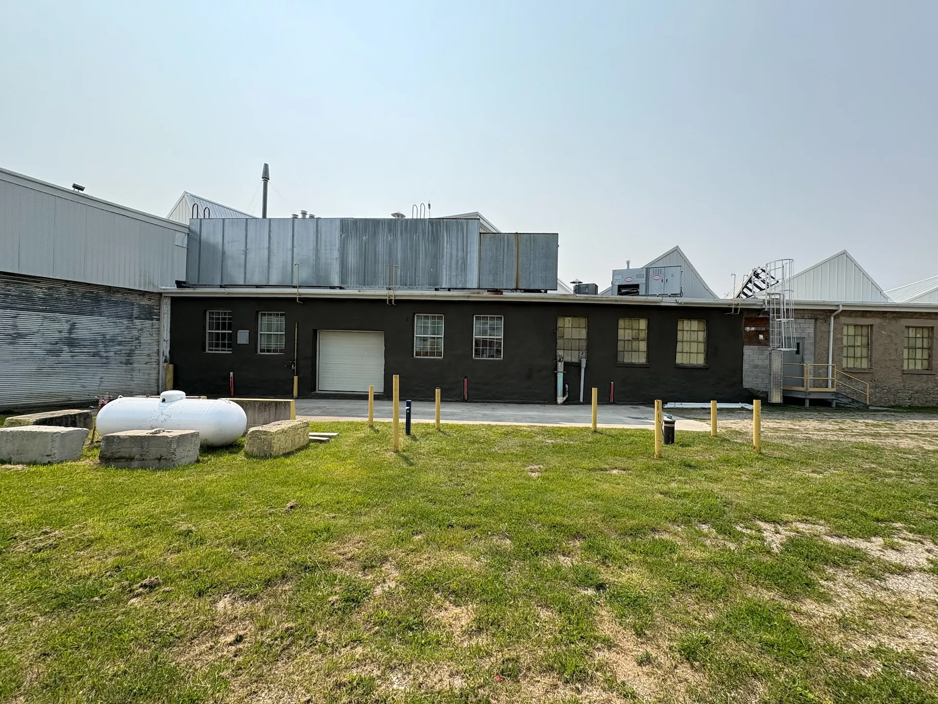 Industrial building wall restoration featuring a reinforced shotcrete (gunite) application and a smooth professional finish to enhance structural durability and moisture protection.