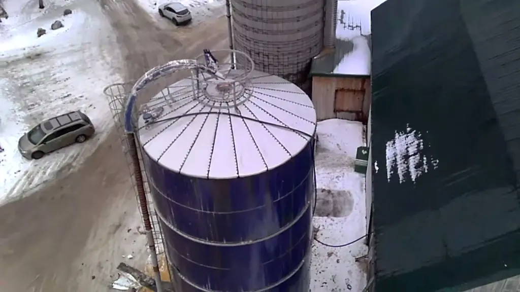 Agricultural contractors replacing a damaged steel silo roof with a new, corrosion-resistant stainless steel roof on a farm near Fergus, Ontario.